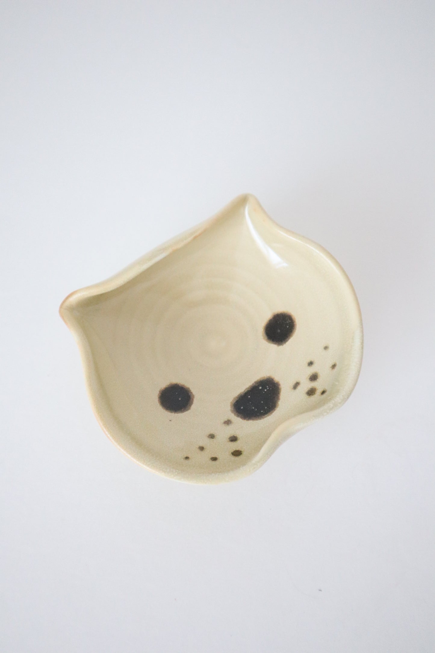 biege yellow small dish made into shape of a bulldog