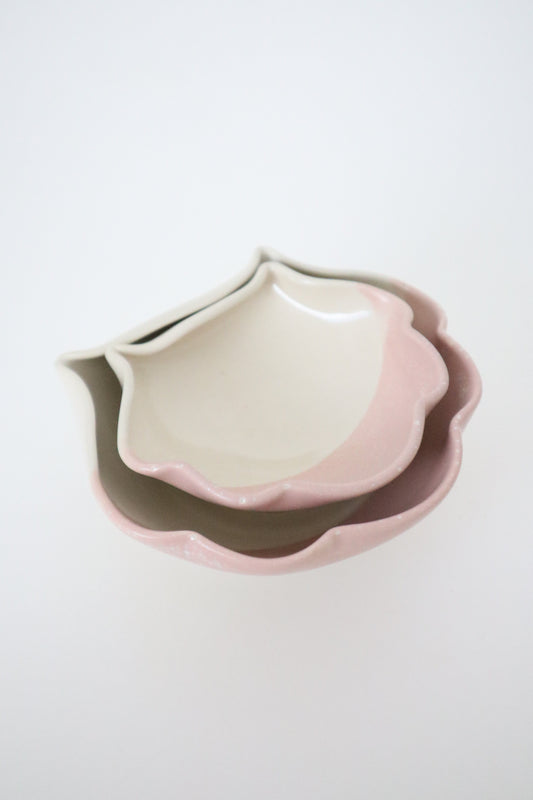 Stack of ceramic bowls with a gradient design on a white background