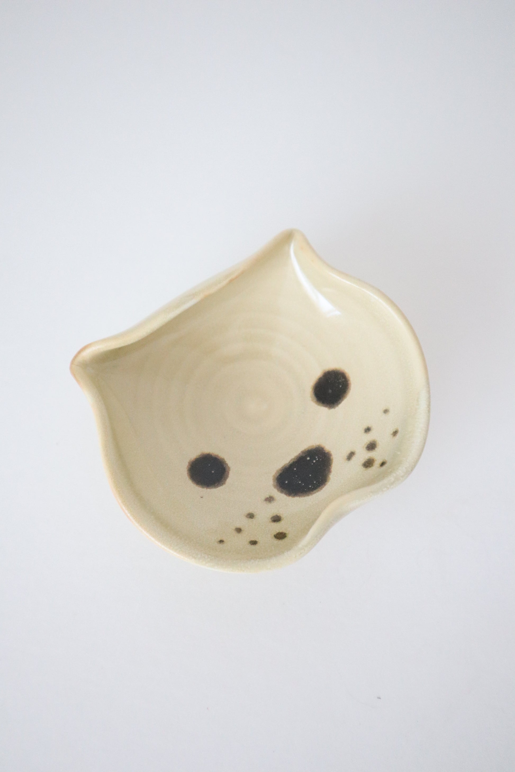 biege yellow small dish made into shape of a bulldog
